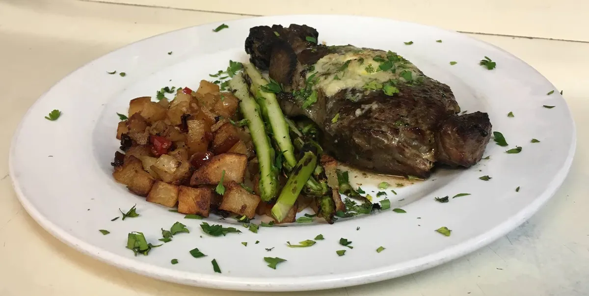 A plated dinner with vegetables at Rocco's Town House