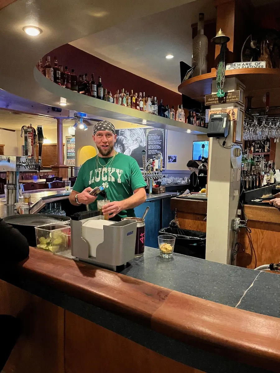 A bartender welcoming guests at the Town House bar